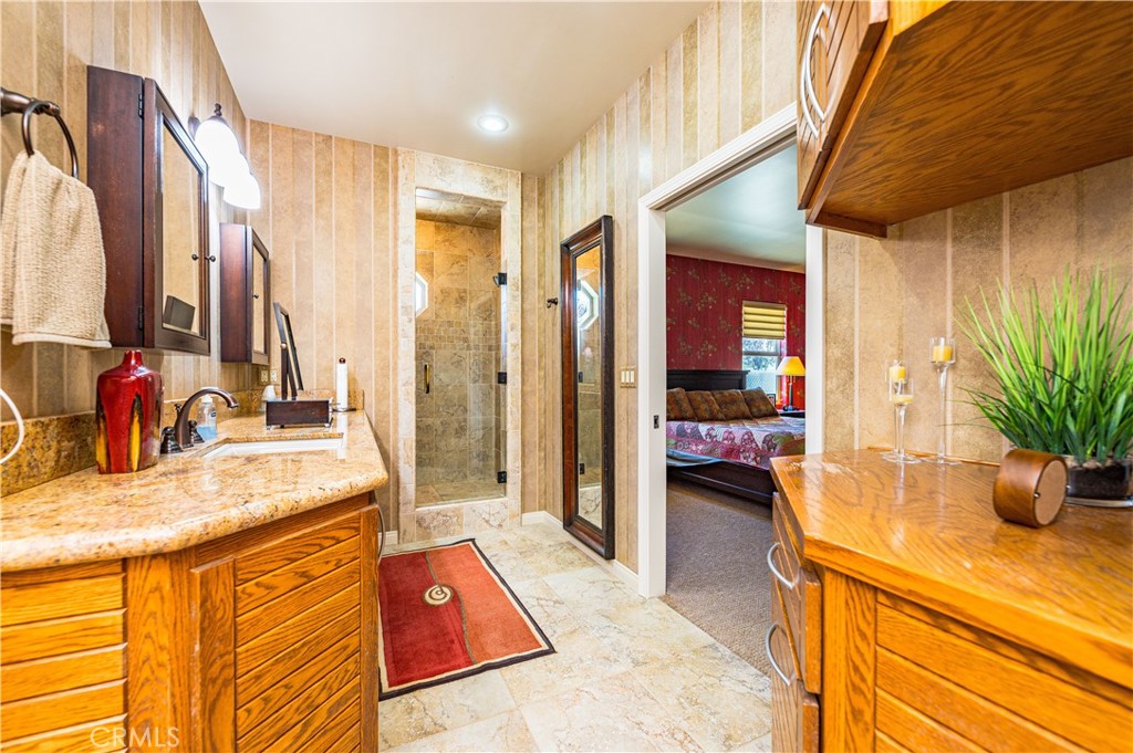 Primary Bathroom with Walk In Shower, Granite Counters, Double Sinks and Linen Cabinets