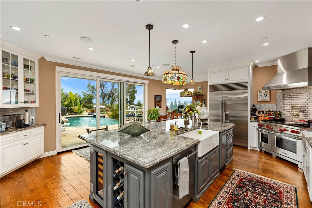 Large island with sink, dishwasher and microwave oven. Not: the Wolf range has double ovens and commercial grade hood.