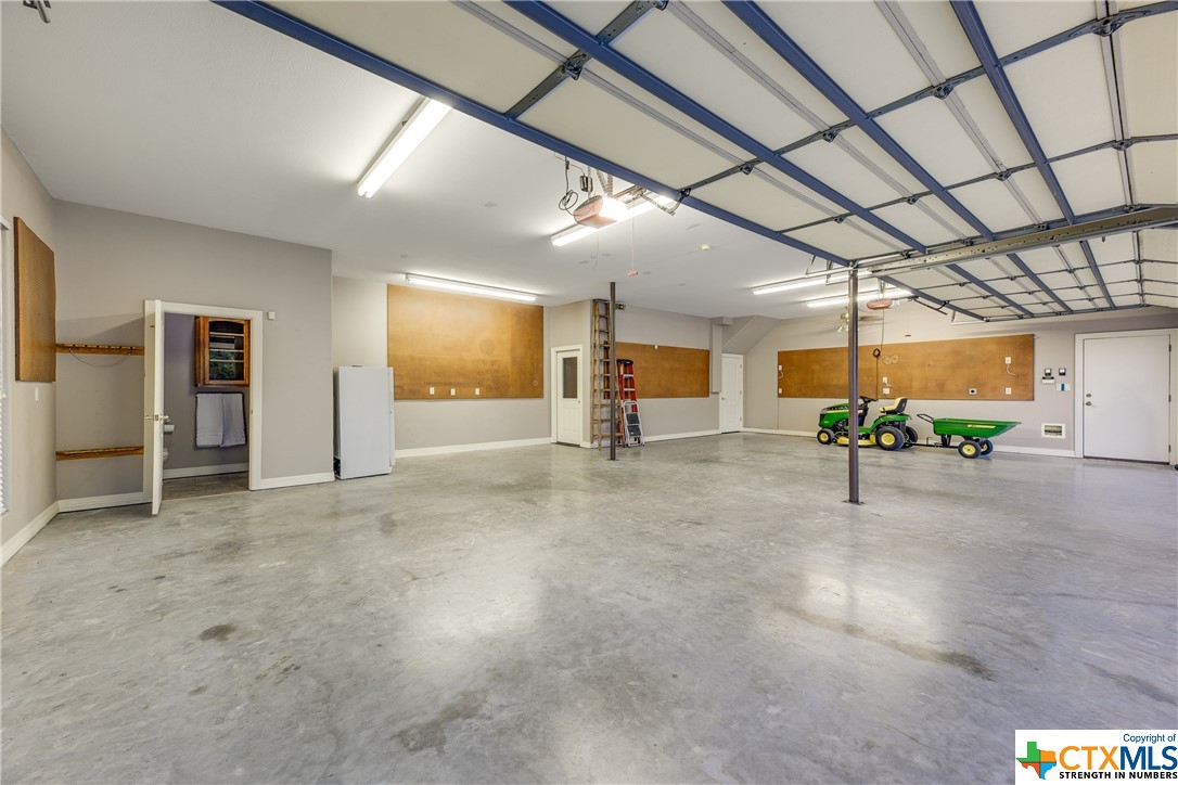 Oversized 4-car garage with 1/2 bath & extra storage