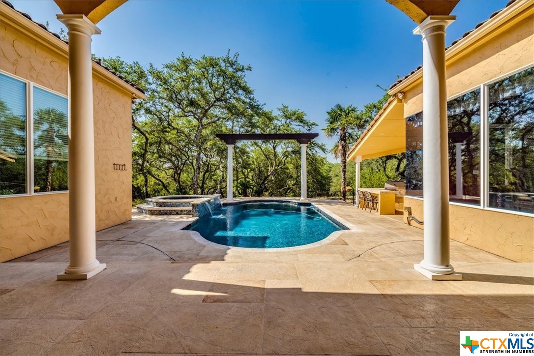 Your outside oasis featuring salt water heated pool