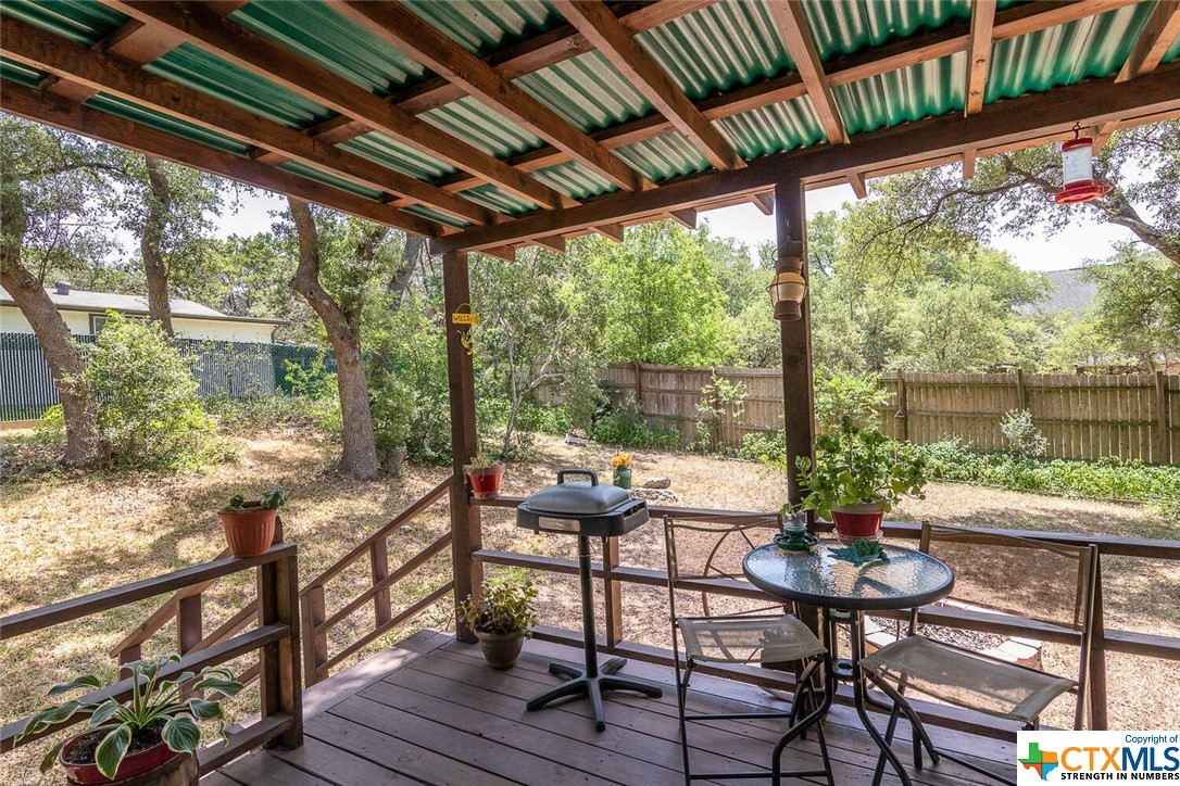 Fenced yard Covered patio and mature trees.