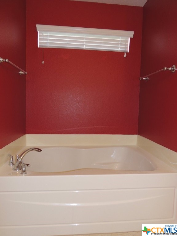 Enjoy a relaxing bath in this large garden tub in the luxurious owner's bathroom.