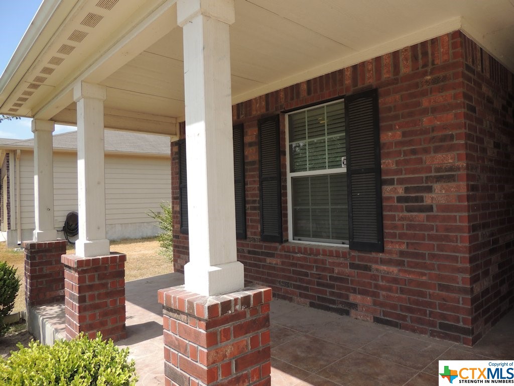 The brick columns and tile porch compliment this lovely home.