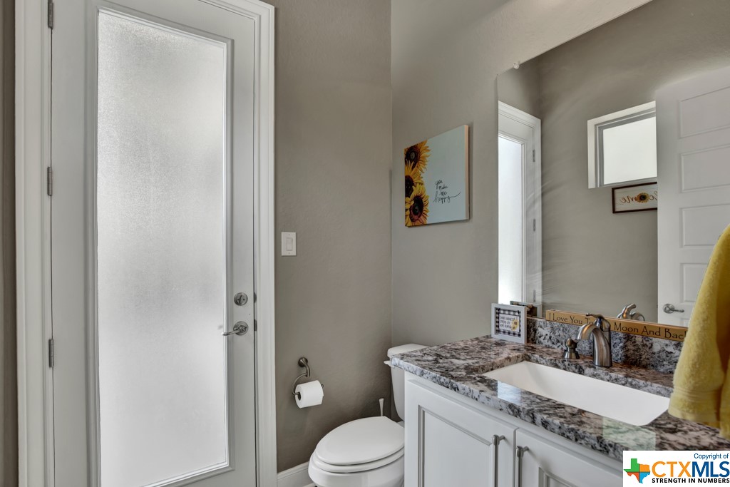 powder room off the gameroom with door to the pool and spa
