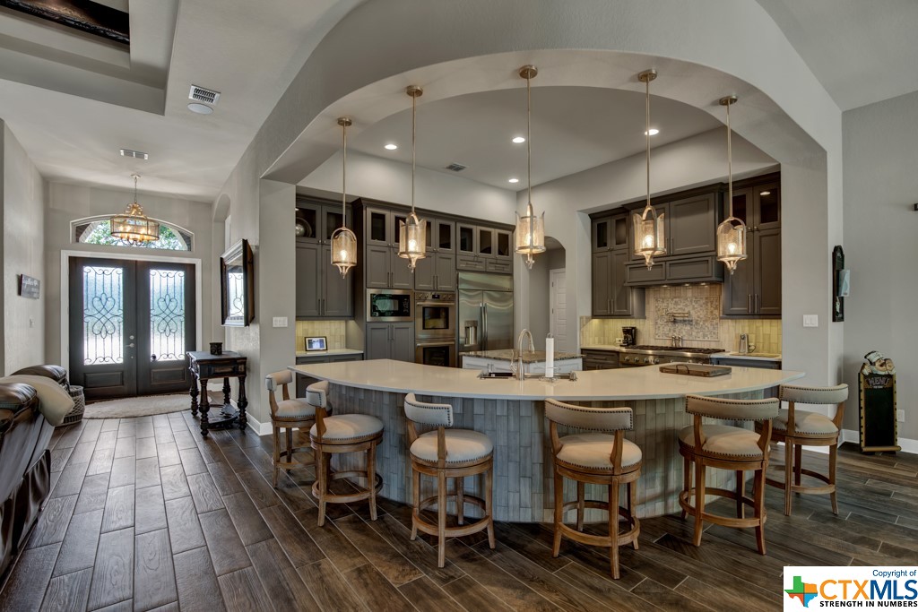 Large gourmet kitchen with custom cabinets and upgraded appliances