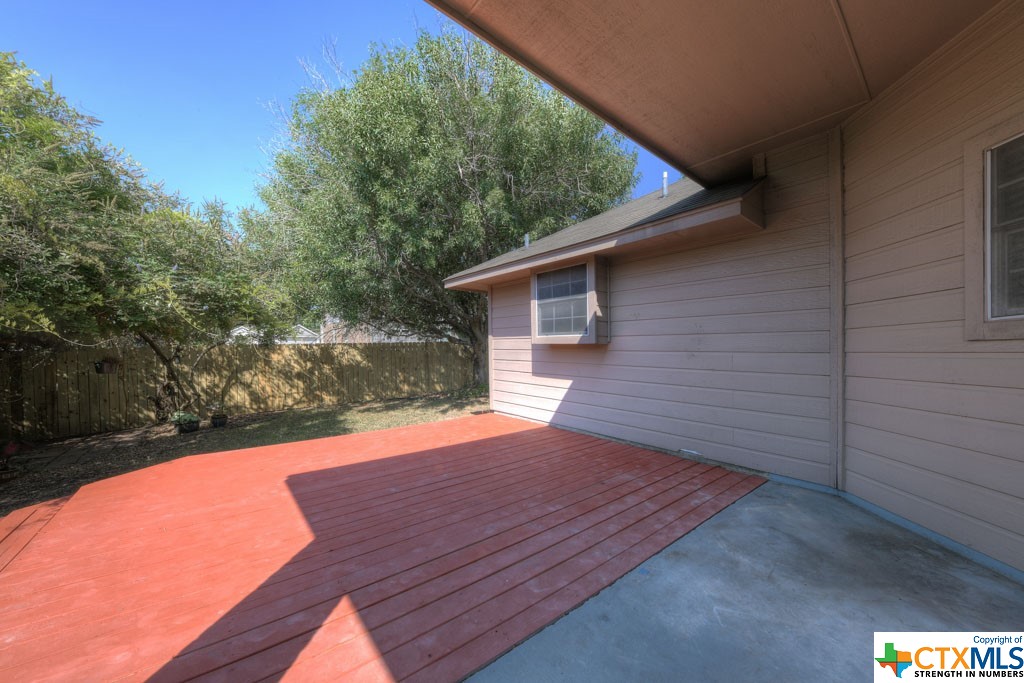 Rear deck leads to shaded, private, fenced back yard