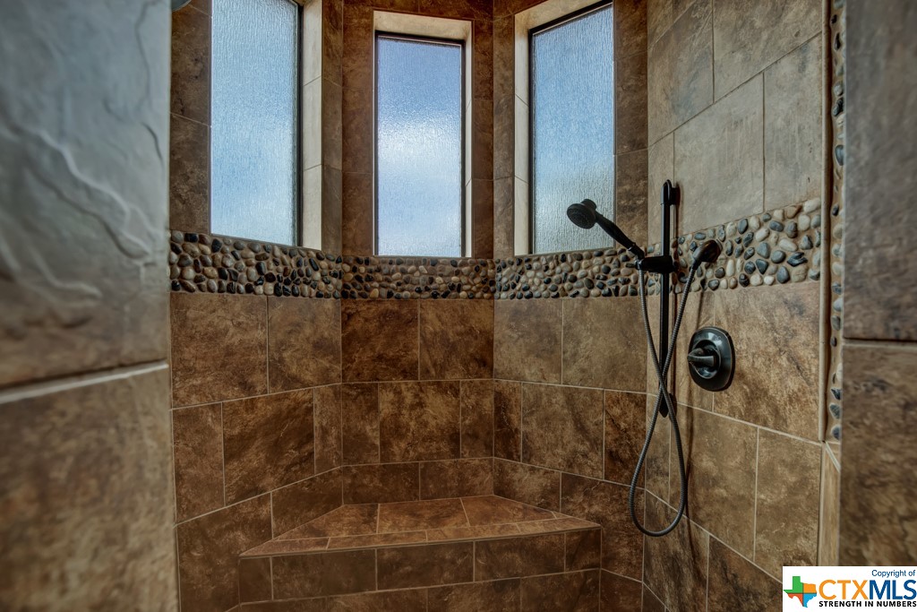 Huge tiled shower with seat