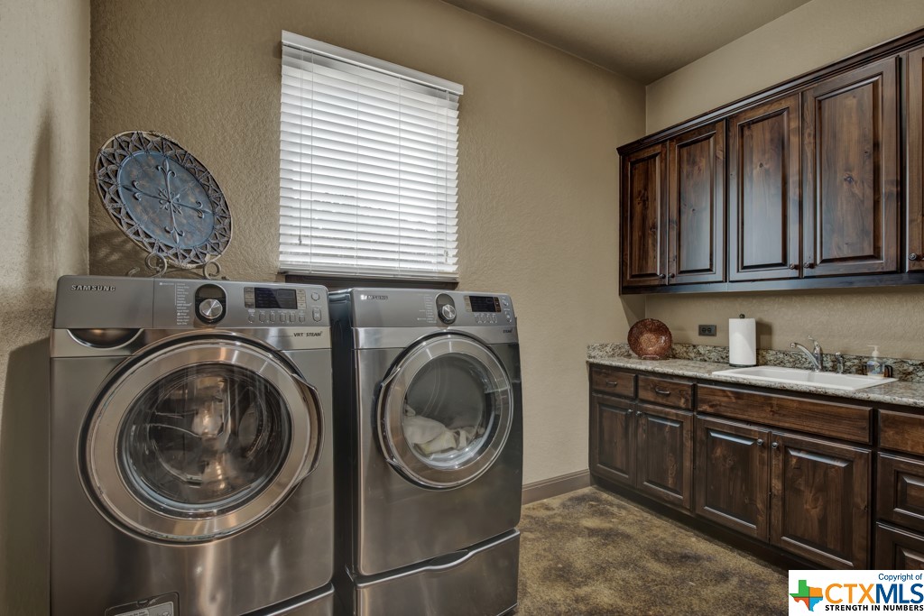 Laundry room with sink and built ins.