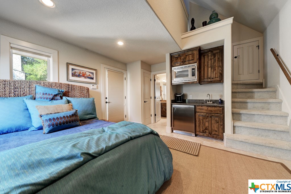 Spacious enough to feature a bedroom set or a living room set, the downstairs of the pool house boasts a closet, full bathroom, and kitchenette complete with sink, mini fridge, and microwave. The loft of the pool house is home to two twin beds, which are negotiable.