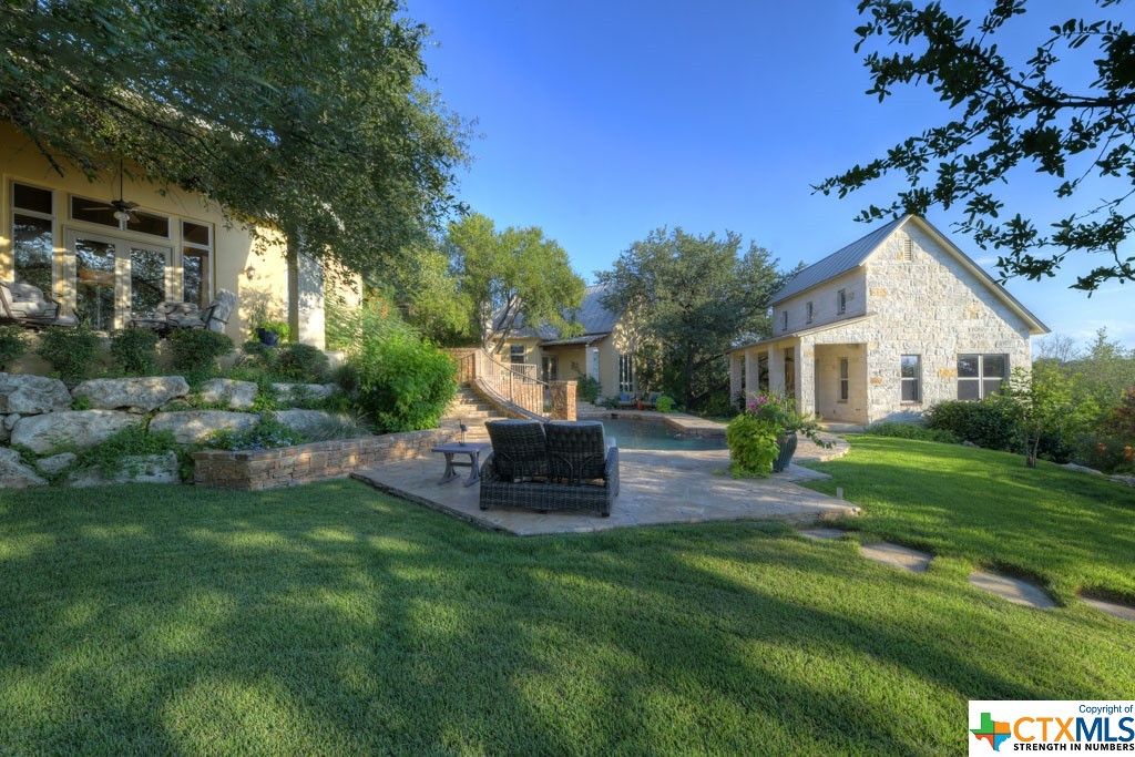 Additional patio seating is available throughout the divinely landscaped back yard. Shade is plentiful as the property boasts many mature oak trees, allowing for relaxation while lounging pool side.