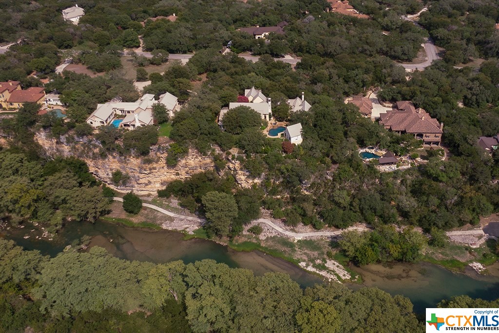 The neighborhood park along the Guadalupe River is at the bottom of the bluff this magnificent property overlooks.
