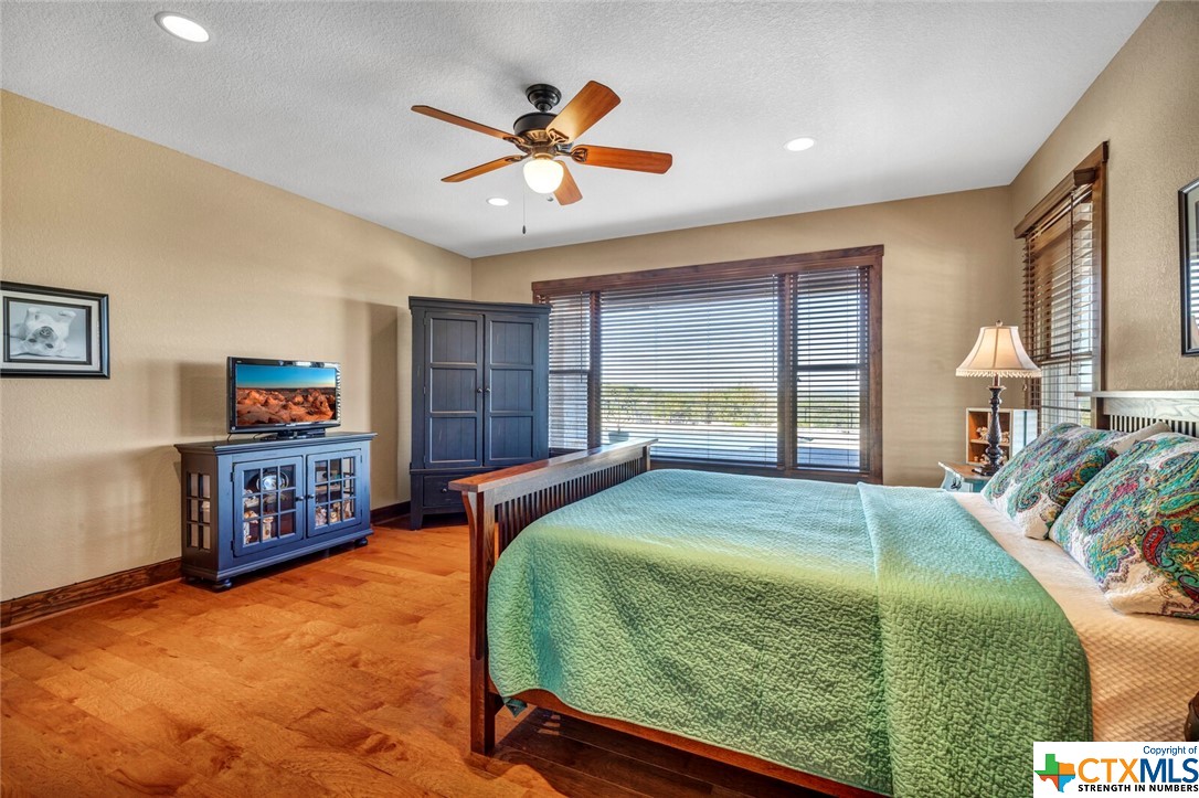 Down master suite showing view toward pool and horizon.