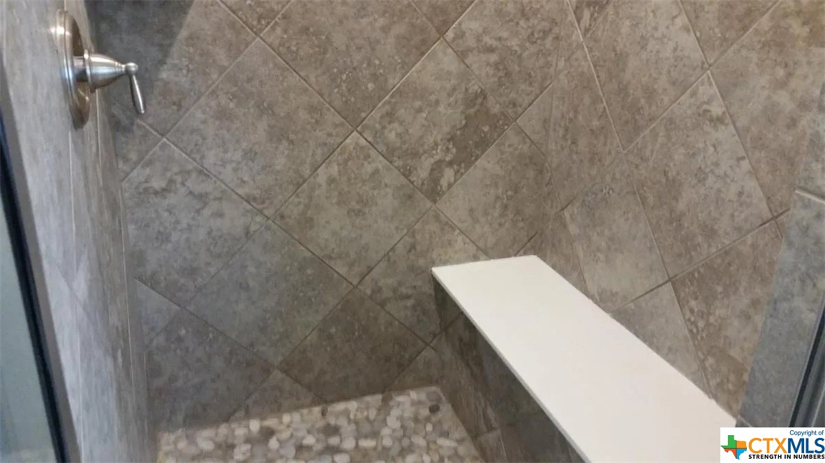 Walk-in tiled shower with bench