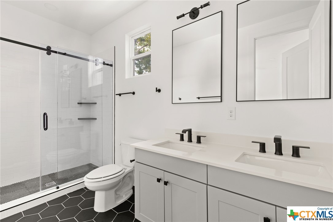 Primary bathroom with great size shower, double vanity and quartz countertop.