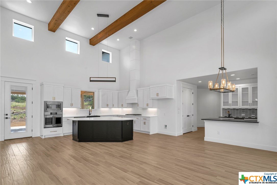Kitchen: Upgraded appliances, sleek finishes, soft close cabinets, marbled quartz  counters