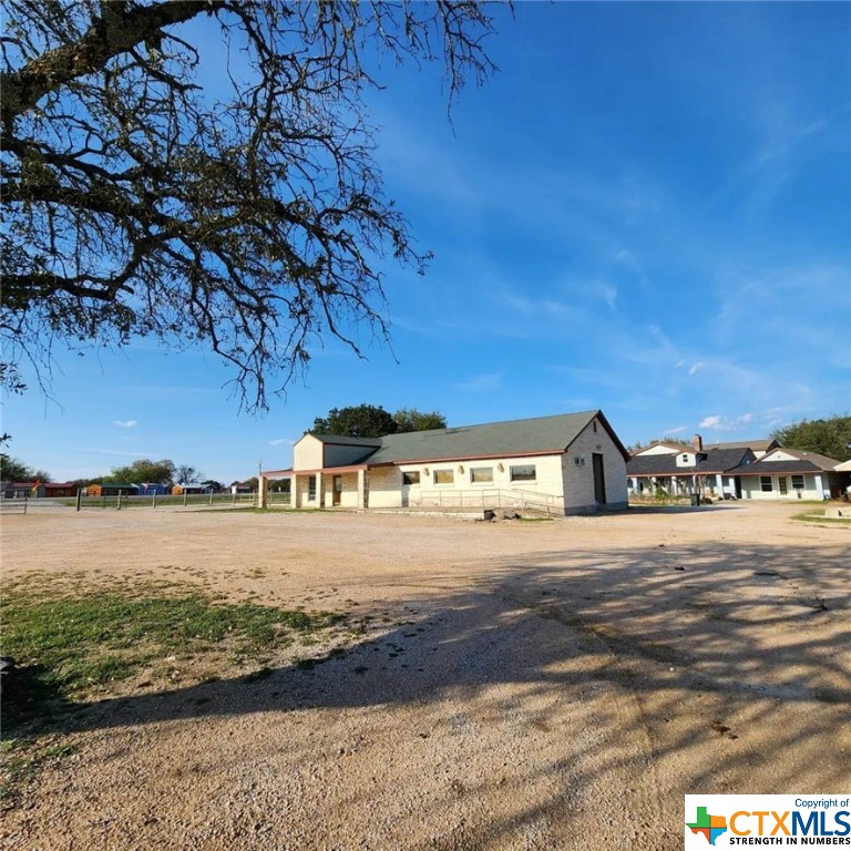 Now this beautiful commercial acreage includes an extra lot!  With Highway 190 frontage, has 4 different buildings plus some!  A large open-floor plan Commercial Building, with a commercial kitchen, walk-in cooler, 2 sets of restrooms, with large open main area.  Main house is 3Bds/1Ba, a 2Bds/1Ba upstairs rental unit with an awesome view!, a 6-Room ranch hands quarter with central kitchen and bathrooms.
The unique set-up is suitable for a venue & retreat, country store, food & meat market, taqueria, grocery, or a church retreat with soup kitchen, with room & board for members or employees.  Plus, you have the rest of the 7.75 acres to expand your vision of a forever home with income producing investment set-up as well!

NOTE:  **This is a family acreage with 2 lots with 2 diff family members' names on CAD; PID #5058 is 6.62 acres & PID #20420 is 1.13 acres.  Please see Bell CAD.**