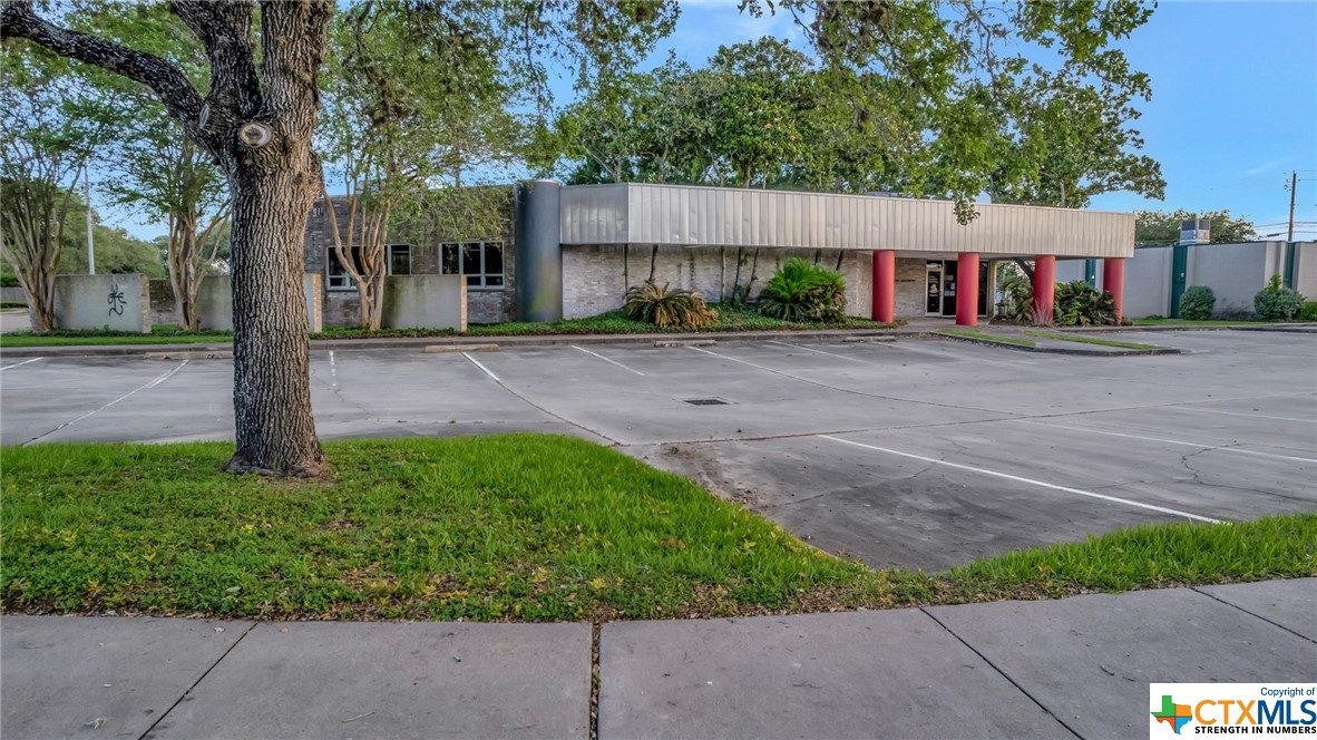 Spacious and centrally located in Victoria, TX.  This 4200 square foot building sits on just under a 1/2 acre corner lot and has many possibilities.  Ample parking with 2 private spaces near a rear entrance.  Nice reception area with check in desk and office area.  Several individual offices/rooms with 1 large open area. Private office at rear of building with personal bath.  Property features a modern flare and is nestled among several other commercial office buildings.