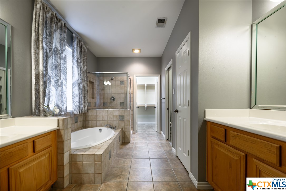Master bath with garden tub, separate shower and dual vanities.