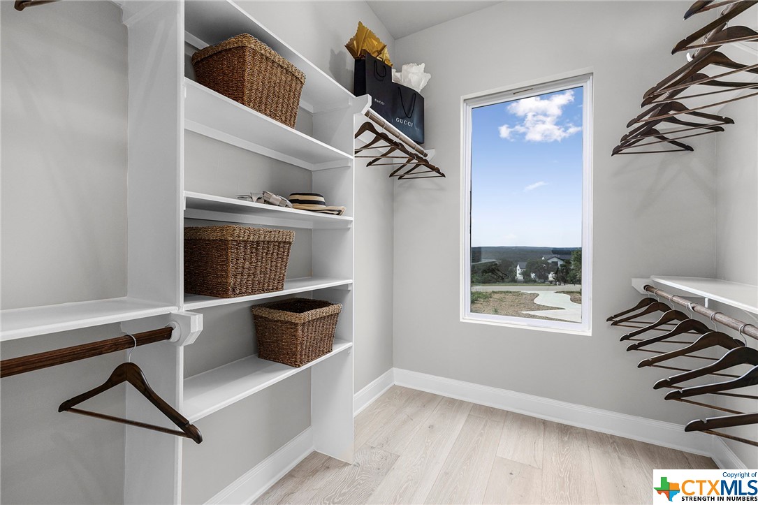 spacious closet with built in shelves