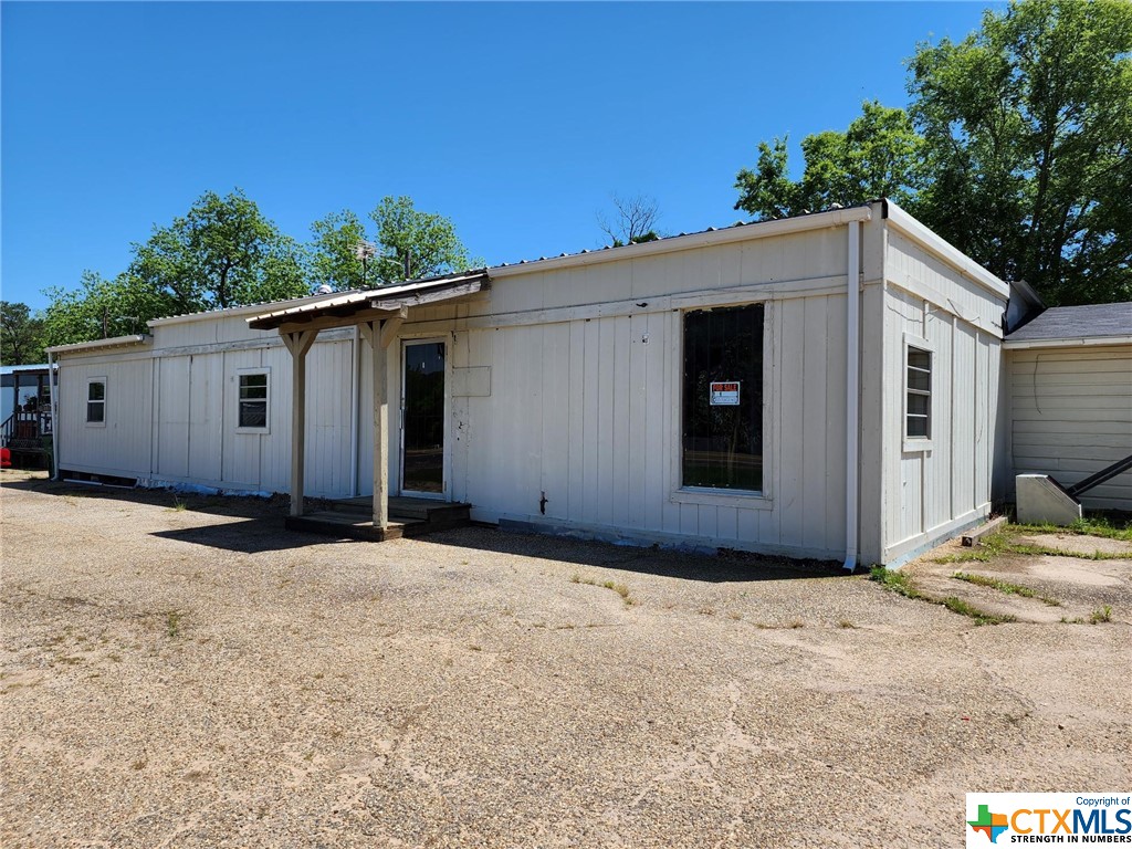 COMMERCIAL building and mobile home property are available as a package, with over 1500sf of retail space. Good traffic on SH 154 W, makes this a great location for your small business!