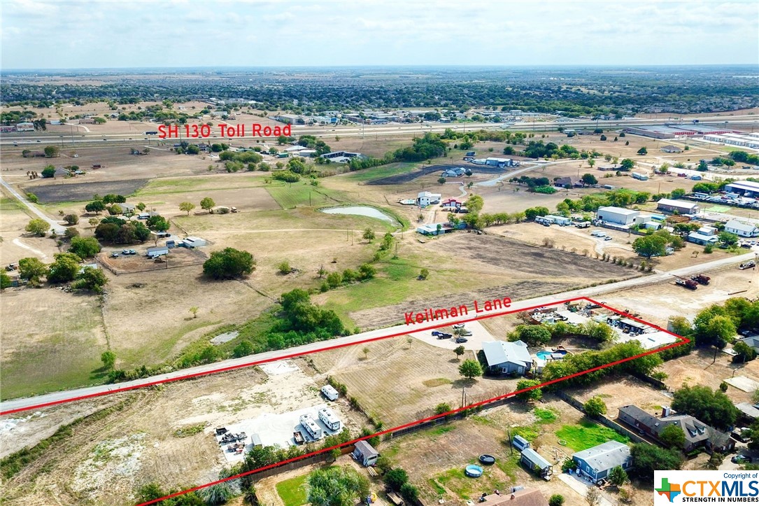 Rare, unrestricted 3.998 acre unique commercial property conveniently located just 2 minutes from TX 130!! Developed portion of property has 1679 sq ft of Office/living space, 270 sq ft additional air conditioned office space, a 450 sq ft covered storage area and a fenced 2200 sq ft Metal Warehouse building with 5 bays! Developed area has parking for approx. 30 vehicles. Property offers a Designer pool, patio and outdoor bath house for your Business entertaining!! Undeveloped portion of the property on the right side has a driveway to a 7200 sq foot concrete pad ready for your business possibilities! Property is Turn-key minus personal property and ready for your business to grow!! This unrestricted area presents many great commercial possibilities in an Explosive growth area; Ease of access to major roads SH130 and SH45, Pflugerville ETJ; No HOA or city restrictions. Total square footage of main bldg, extra office space, covered storage, pool bath house and Warehouse building = 4663.