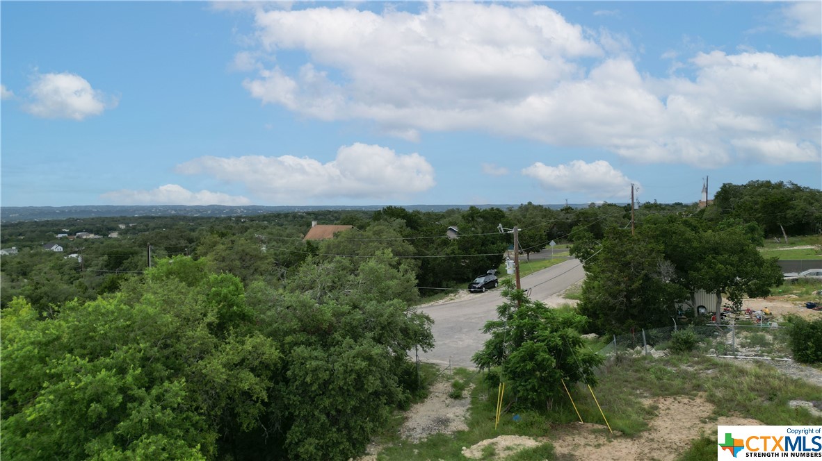 Oversized lot to build your dream home.  Great hill country and lake from a 2nd floor that is at an extremely affordable price. This lot is cleared and ready to be built on.  Survey available. Neighborhood has relaxed restrictions and STR's allowed.  The neighborhood is full of amenities with a community swimming pool, clubhouse and playground. Close to Cranes Mills Marina, Comal park and shopping.