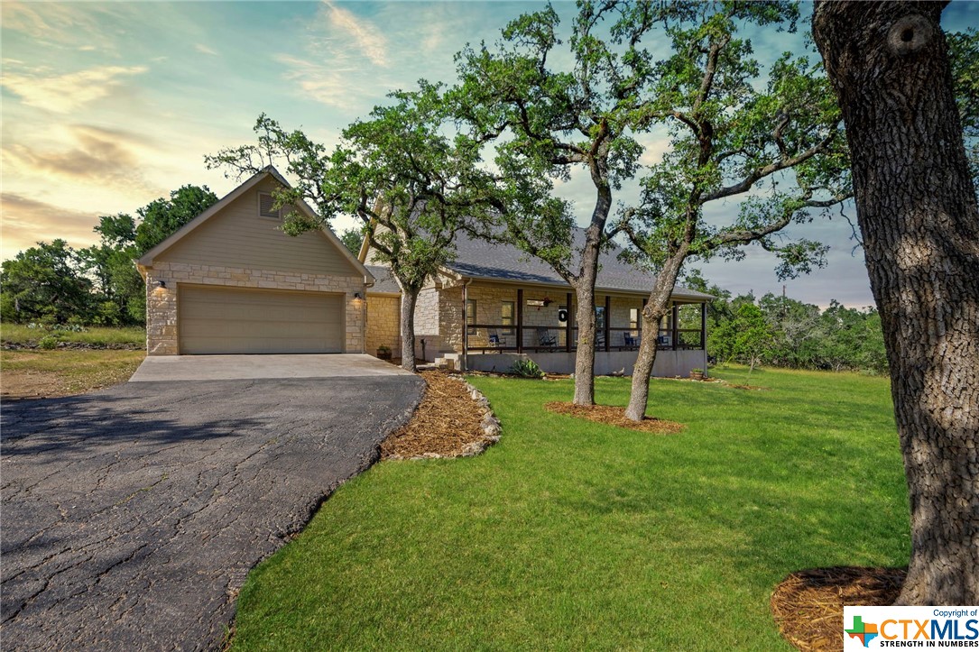 NEW HILL COUNTRY LISTING! CUSTOM ROCK HOME BEAUTIFULLY SITUATED ON 5.01+/- GENTLY WOODED ACRES W/3 BEDS, 2 BATHS, 2-CAR GARAGE W/WORKSHOP! PAVED DRIVEWAY! STUNNING FRONT PORCH OVERLOOKING FRONT YARD & MAJESTIC LIVE OAK TREES! LUXURY VINYL PLANK FLOORING, NEWLY REMODELED KITCHEN AND OPEN FLOOR PLAN, & SHIPLAP WALLS. KITCHEN FEATURES CUSTOM KNOTTY ALDER CABINETS, CENTER ISLAND WITH WITH WATERFALL QUARTZ COUNTERTOP, PROPANE COOKTOP, S/S APPLIANCES INCLUDING ICEMAKER.MASTER SUITE W/DOUBLE VANITY, WALK-IN SHOWER & GENEROUS WALK-IN CLOSET. SECONDARY BATH HAS BEEN TASTEFULLY UPDATEDSPACIOUS COVERED BACK PORCH, FENCED IN BACKYARD AREA, ROCK PATIO WITH FIREPIT. ROOM OFF THE BACK OF GARAGE MAKES A NICE WORKSHOP OR COULD BE AN OFFICE. ADDITIONAL FLOORED STORAGE OVER THE GARAGE ACCESSED BY STAIRS. OCCASIONAL ROAMING EXOTICS! HORSES OK! GATED SUBDIVISION. HOA PICNIC PAVILION & TENNIS COURT/SPORTS COURT.