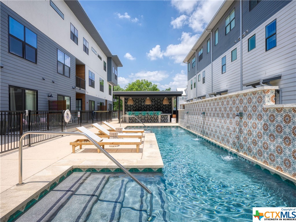 Introducing a Stunning Downtown New Braunfels Condo with Community Pool in Town Creek! Welcome to this exquisite 2 bedroom, 2 bath condo with a covered patio and two designated parking spots nestled in the heart of downtown New Braunfels. Boasting a prime location next to shopping and restaurants, this property offers the perfect blend of modern comfort and urban convenience. As you step inside, you'll be greeted by an inviting open floor plan that seamlessly combines the living, dining, and kitchen areas. The primary bedroom is a peaceful retreat, complete with a private en-suite bathroom for added convenience and privacy. The second bedroom offers versatility and can serve as a cozy guest room, home office, or hobby space. One of the standout features of this condo is its access to a community pool, Dog Park, BBQ grill area, and Amazon lockers. Beyond the comforts of the home, you'll find an abundance of amenities at your doorstep.