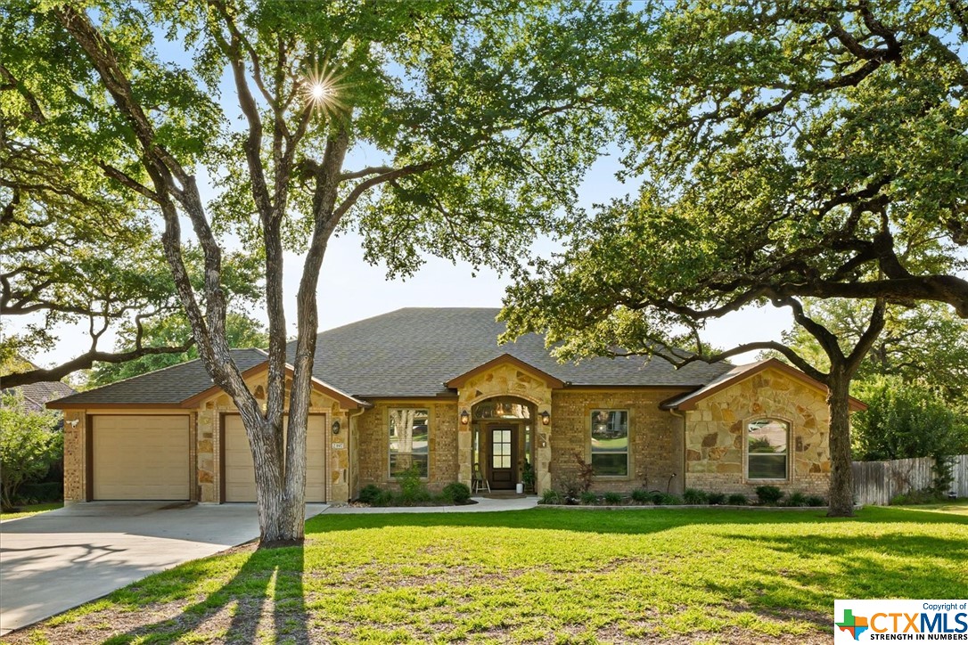 Come live splendidly in this gorgeous single-story home in the sought-after High Crest neighborhood! This Carothers Executive Home will surely be your all-season oasis. Enjoy sunsets from the comfort of the covered patio overlooking hill country with mature trees. Vaulted beamed ceilings in the main living area give natural light and an expansive, luxurious feel. The open floorplan featuring a floor-to-ceiling stone fireplace is the perfect place for entertaining and creating new memories. The kitchen is well-appointed with granite counters, beautiful tile backsplash, large pantry, double oven and custom wood cabinetry. The primary bedroom is a quiet retreat featuring an ensuite bath with a soaker tub, dual vanities, oversized shower and large walk-in closet. Roomy secondary bedrooms with high ceilings, large windows, two secondary baths with granite counters, and upgraded finishes complete the thoughtful floorplan. A dedicated office with French doors is perfect if working from home.