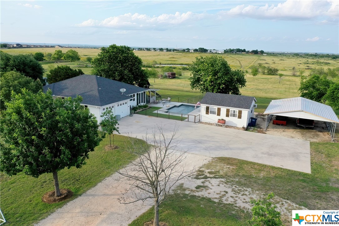 After a long days work you can't imagine a more beautiful place to escape the hustle of the world. The sunsets will blow your mind! This 3/2 rancher on 5 acres has everything you could want! Huge detached flex room, updated kitchen, no carpet, in ground fully fenced pool, chicken coop, carport, epoxy attached 2car garage, covered back porch, fenced in backyard and the list goes on and on!!