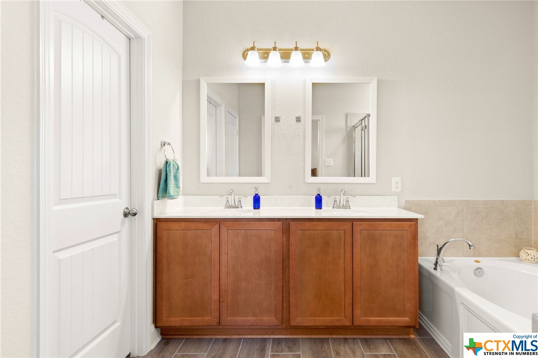 Dual vanities with stylish, separate mirrors in the primary bathroom.