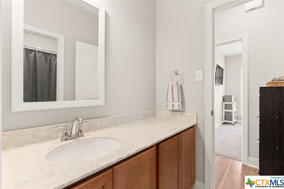 The 2nd full bathroom has a large countertop space, plenty of cabinet storage, conveniently connects the 2nd and 3rd bedrooms.