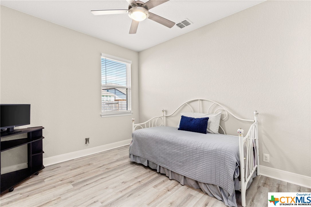 The 3rd bedroom shows off its recently-installed luxury vinyl plank flooring as well as its updated ceiling fan.