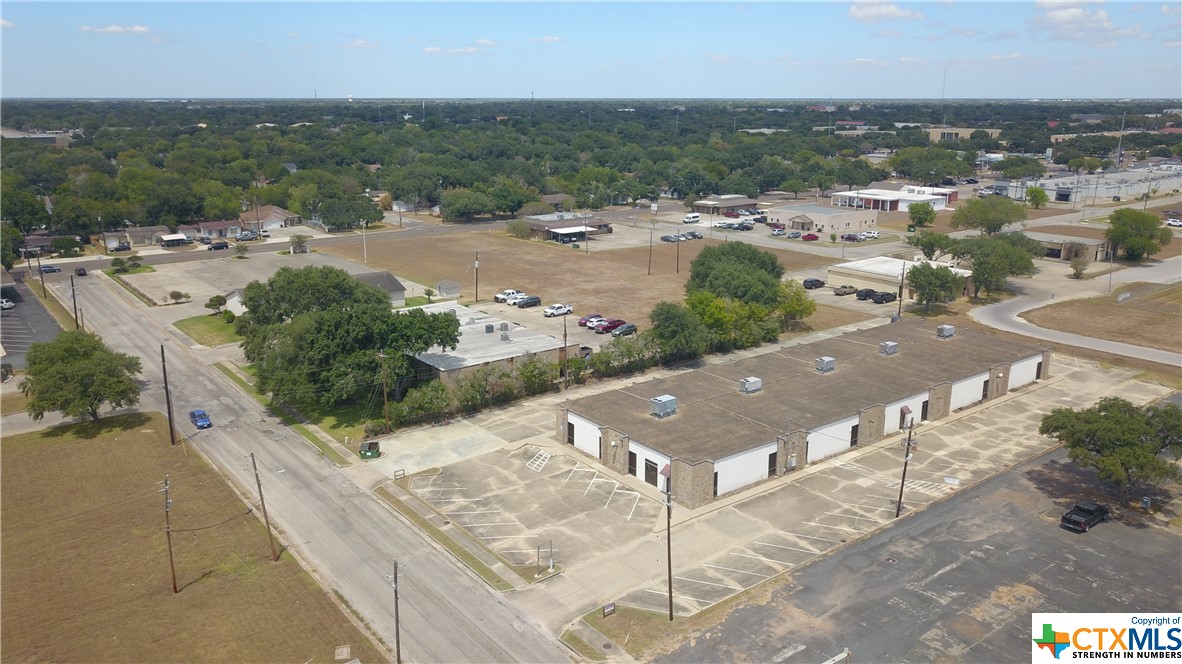 Single story building on 1.2105 acres centrally located in Victoria, Texas.  This building is currently divided into three sections.  2,830 sq. ft is occupied by a tenant, lease expires 10/31/2023, $1,637. monthly plus pro-rated gas, water and sewer.  The interior has drop ceilings, carpet and VCT tile.  There are 5-10 Ton package HVAC units with gas heat, ages unknown.  The roof is tar and gravel and is 15+ years old.  The building is serviced by one gas meter, one electric meter and one water meter.  There are multiple entrances to the building.  The exterior is brick veneer and stucco.