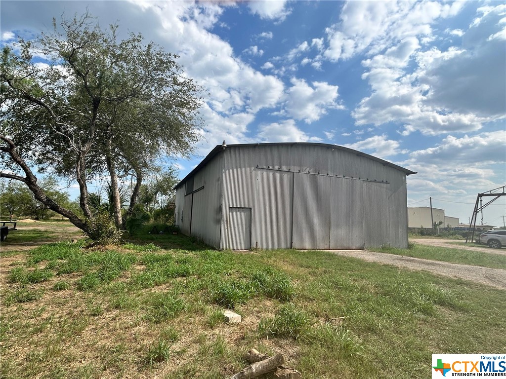 This property features approximately 400 feet of US-59 highway frontage, a large metal building, 40' x 70' with 4 sliding bay doors, a smaller metal building 30' x 40'. There are 3 storage buildings on the property, 160 sf, 80 sf, 96 sf. Has been previously used as a welding shop, but would be well-suited for automotive repair or any type of fabrication shop, possible residential, outside of city limits no zoning or restrictions. Situated on 2.62 acres with good perimeter fencing.