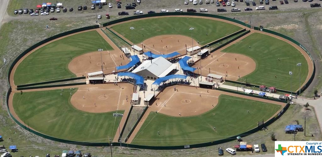 *19 ACRES* -  The Fields At Huber Ranch is one of the Southwest United States' premiere destination for competitive  girls fastpitch softball.  This highly utilized property offers 5 professionally maintained fields, food service center, retail and rentals.  Located on a corner lot and surrounded by a fast growing development of residential subdivisions.