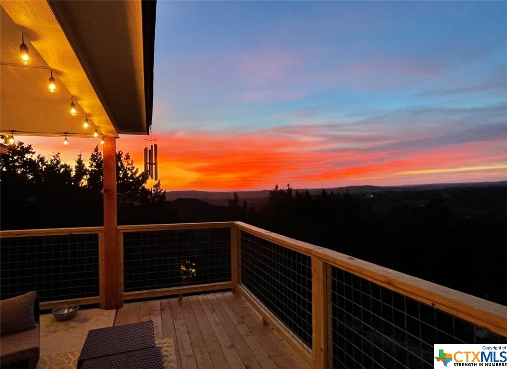 This stunning photo captures a mesmerizing sunset view from the back of the hill country home.  The sun's warm, golden hues cascade across the sly, casing a soft, inviting glow over the landscape.  It's a breathtaking spot to unwind and enjoy the natural beauty that surrounds this property.