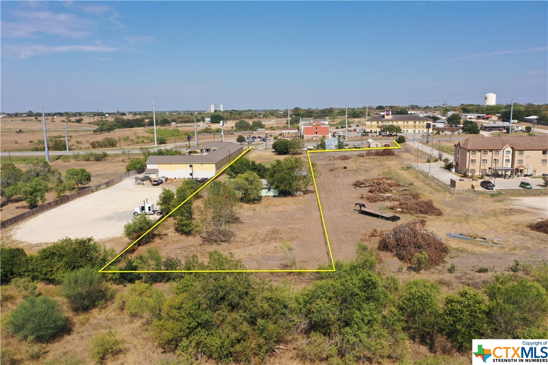 This property can provide plenty of room for a multitude of business types or could even continue to be used as a homestead. The property consist of two parcels that front US HWY 183. The smaller of the two has an existing 1440 SF +/- (per CAD) metal building that was once used as a muffler shop. The second, and larger tract, has a 1152 SF home (per CAD) and several other outbuildings on it. Both parcels combined have approximately 295 +/- feet of frontage on US HWY 183. City services are in front of the property at the HWY. A portion of the mineral estate could be negotiated with a full price offer.