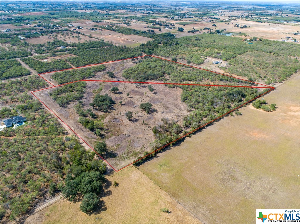 Dry Hollow Creek Ranch Lots 14 (this listing) & 12 (a second available listing 521636) are located off Felix Rd in St. Hedwig, TX in Bexar County.  These 2 Ag Exempt tracts are over 20 acres each with wooded countryside waiting for you to build. Buy one or buy them both as they share a common boundary.       These beautiful tracts are located just 4 miles from HEB in La Vernia but feel miles away when you drive in your front gate. Sit on the back porch in the morning and watch the deer and other wildlife as you have your morning coffee. Lot 14 is 24.29 acres (Lot 12 is 21.96 acres). These beautiful, single family residential lots include a water meter (provided by Seller) and fully trenched water lines for each. Power is on site and will need a meter (Buyer expense) where you want when you're ready. Come see your big time, small town, country road, new home site in St. Hedwig today.        These single-family residential lots come with some restrictions and each has over 20 acres of ag-exempt partially cleared, partially wooded country side with walking trails dispersed throughout. Both lots have a small amount of 100 yr flood plain, but there are plenty of gorgeous live oak and post oaks covered spots to provide several options for your new home. These country lots are surrounded by sizeable neighboring properties making it an excellent "sanctuary" for the deer, birds and other critters, or home for your cattle and chickens. The animals have all they will need to call this place home including food, water and shelter.       The boundary between the two properties is not fenced, but the perimeter around is cattle ready.