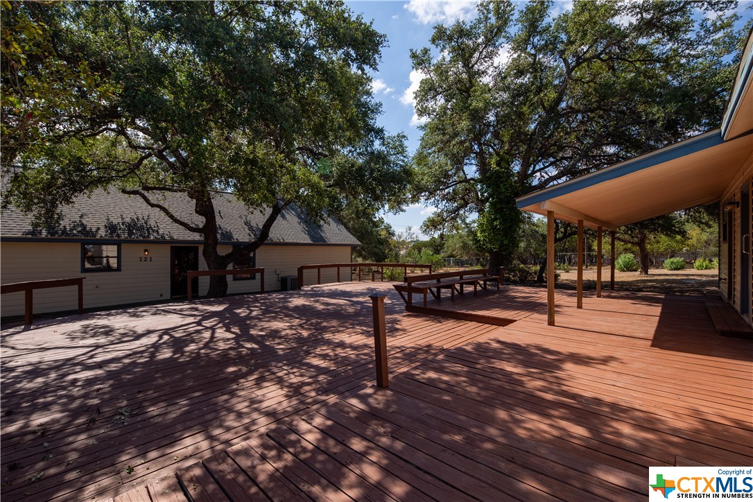 Nestled in the picturesque Hill Country-Canyon Lake area, this 1600 sqft 2-bedroom, 2-bath home is a true gem with tons of potential. With a detached 540 sqft guest suite, a massive 3-bay garage/shop offering ample space for your boat or RV, and a sprawling 0.99-acre lot, this property is a dream come true for those seeking space, comfort, and the beauty of the countryside. The detached guest suite is a true highlight. Equipped with a full kitchen, it offers endless possibilities - from accommodating guests to serving as a home office or even a cozy studio retreat. Car enthusiasts, hobbyists, and outdoor adventurers will appreciate the expansive 760 sqft 3-bay garage and shop, designed to accommodate your vehicles and all your tools and lake toys. Enjoy views of the countryside from the office and front porch. Whether you're working from home or sipping your morning coffee, you'll be surrounded by the beauty of the outdoors. The property is graced with beautiful mature oak trees that provide shade and serenity. The huge deck is an entertainer's paradise, where you can host gatherings, BBQs, or simply relax while taking in the scenic surroundings. The homes roof was replaced in 2021, AC in 2013 and water heater and water softener in 2015! Low property tax rate! This is more than just a house; it's a lifestyle. Embrace the tranquility of Canyon Lake, where you can enjoy the serenity of the Texas Hill Country.