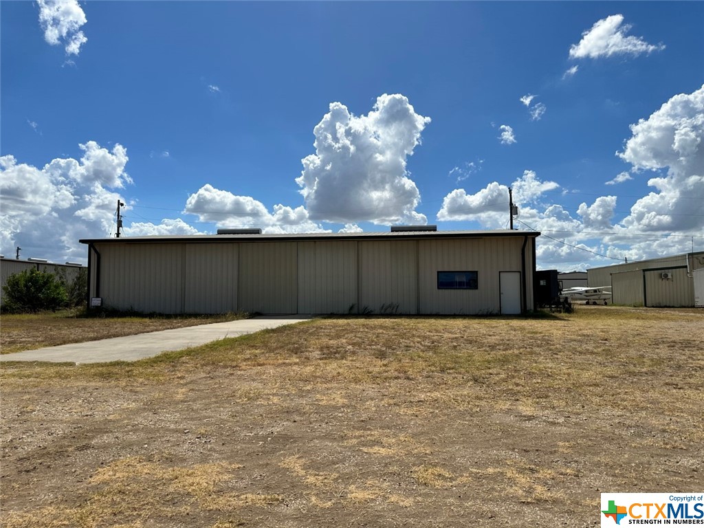 REDUCED!  Almost on the runway of 1TE4 Zuehl Airport - 50x80 Hangar with 1/2 bath w water, septic, electric, Fiber optic .3 acres on concrete slab. 4 doors slide open 12" tall doors!  Door faces N/E. Ceiling is insulated. Priced to sell! Gated community, so please make appointment! Airport is 3000'x 200' solid turf with lights. Used to be be a military field years ago and water does not stay standing. HOA Fees are applicable.