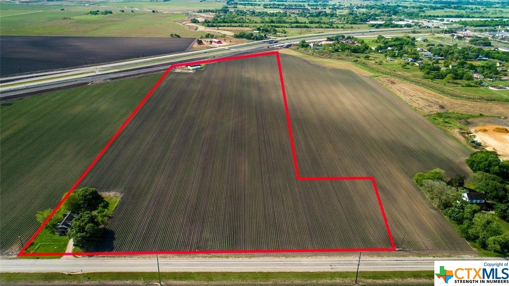 HWY 59 FEEDER ROAD FRONTAGE!! Investment potential with this 22+/- acre tract . Also frontage along FM 1162. Perfect for hotel or manufacturing business!! Includes a domestic water well but is within city limits so city services could be obtained. The land is currently being leased to a tenant farmer. Zoned M-1B. So much investment potential!