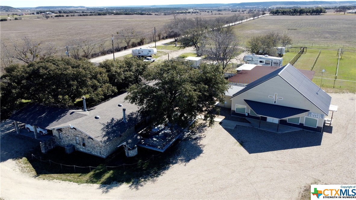 INCREDIBLY VERSATILE property! NO RESTRICTIONS! Privacy galore. Situated centrally between Stephenville, Hamilton, Meridian & Gatesville. Huge, beautiful oak trees. Has been a retreat center w/chapel & RV park. Can continue or could be event center, conference center, hunting lodge, expanded RV park, gun range, golf driving range, any combination, or your family's personal vacation spot. LODGE: inviting rustic bldg w/7501sf, sleeps 45 in 13 sleeping rooms w/9.5 baths. 5 other rooms for offices, workspace, storage, etc. Commercial kitchen w/gas ranges & plenty of workspace adjacent to large gathering/dining room w/2 fireplaces & serving bar. 2nd kitchen in large gathering space w/huge dining table, 2 fireplaces, coffee bar & room to sit/visit. Laundry room w/multiple W&D. Deck to rear shaded by huge oak tree. CHAPEL/EVENT ROOM (built in 2019): 1800sf of mostly open space w/stage, tall ceiling, storage & office. Seats approx 100. RV PARK: full hook-ups for 10 RVs (4-50amp, 6-30amp) restroom bldg w/showers, laundry facility/bldg, covered outdoor area. OTHER IMPROVEMENTS: outdoor recreational area bathroom bldg w/attached rec room, storage bldg, large barn, firepit, awning area, human foosball enclosure. Most FF&E convey. Ask Realtor for list of the FF&E that do not CONVEY. New roofs in 6/23. New well pump in 1/24. 6 HVACs.