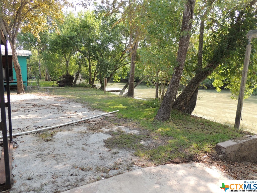 GUADALUPE RIVER FRONTAGE!!! This listing consists of a 14 tap RV park with well stocked pond and a 50' x 75' metal building with a canopy and 5 additional taps. Each RV space is 75 feet. Water well and boat ramp on property. The laundry room includes 2 washers and 2 dryers. The road grader is included in sale. There is open parking on the property.