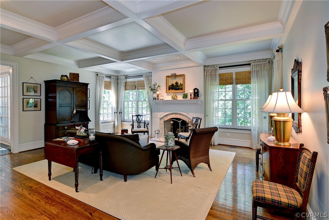 The large family room offers a coffered ceiling, built-ins, fireplace and wet bar.
