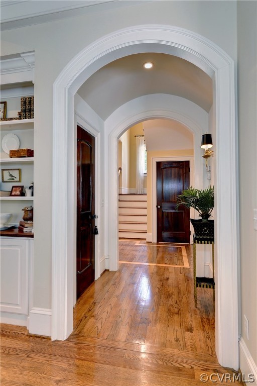 Arched doorway leading from the family room to the foyer.