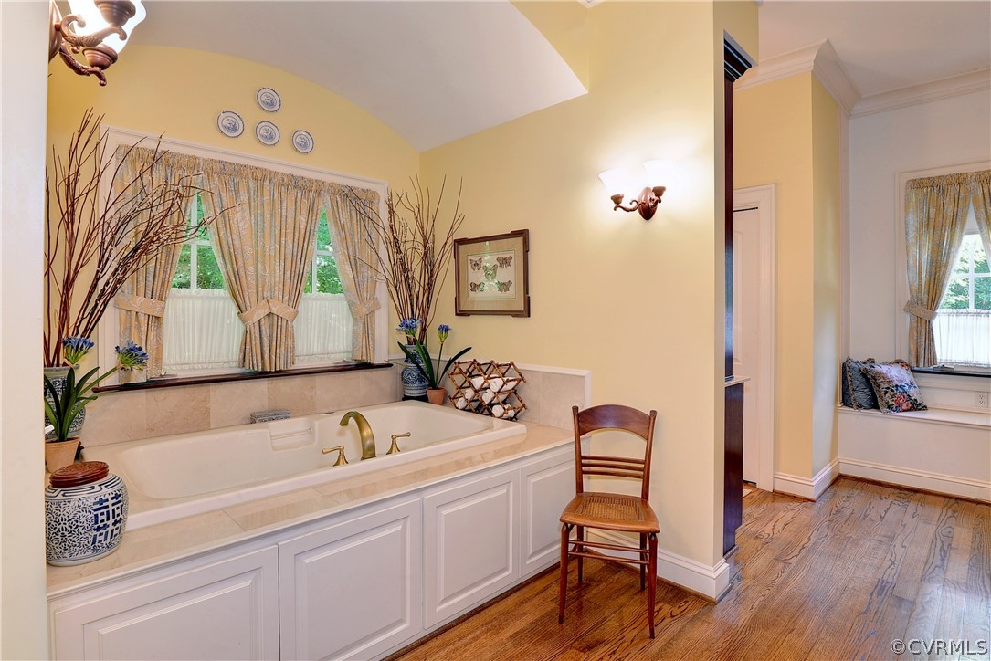 The expansive primary bath has a deep air-jet tub which is flanked by two vanity areas.