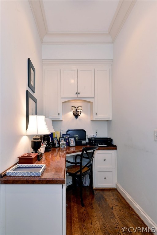 Accessed from the kitchen, this area features a built-in desk with filing cabinet, custom cabinetry, plus upper shelves for more storage.