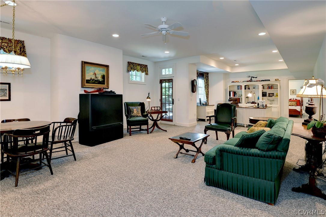 The lower level is carpeted throughout with an area for watching TV, playing games, an office area and a bedroom.