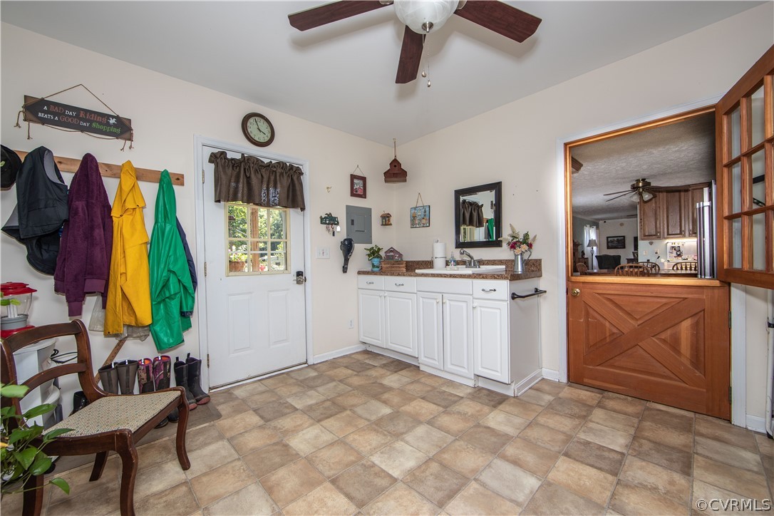 The mudroom is the perfect drop zone. It boasts durable laminate flooring, lots of cabinets, and ceiling fan.